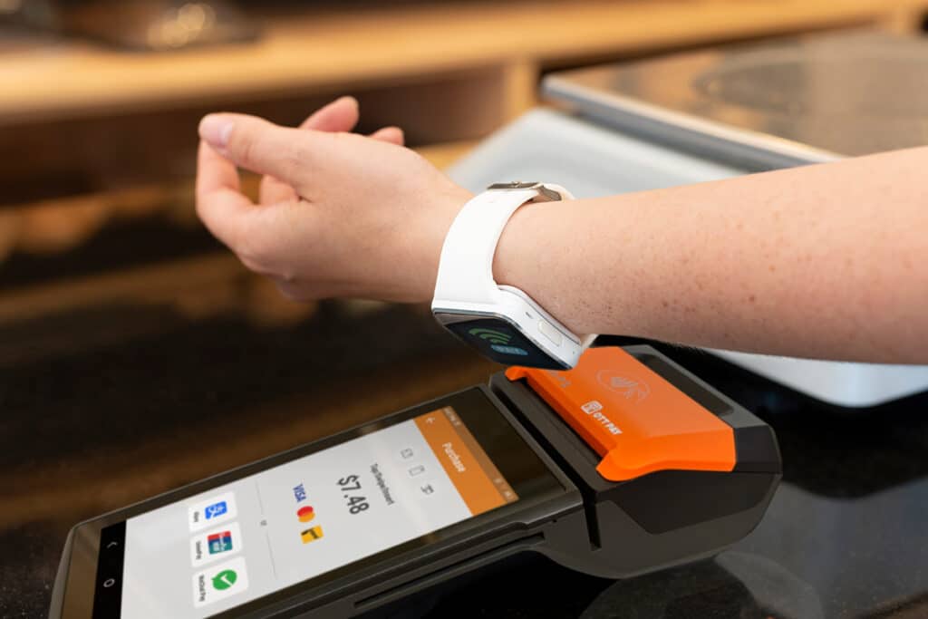 Close up of customer paying with their smartwatch on an OTT Pay Credit & Debit Card Machine