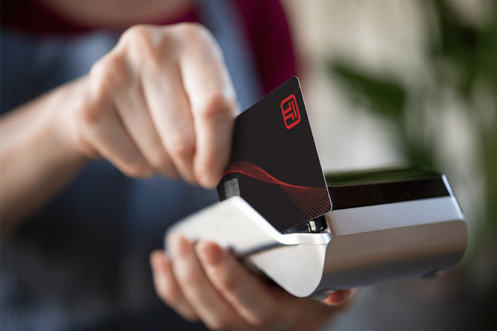 Closeup of a customer swiping their credit card on a credit card terminal